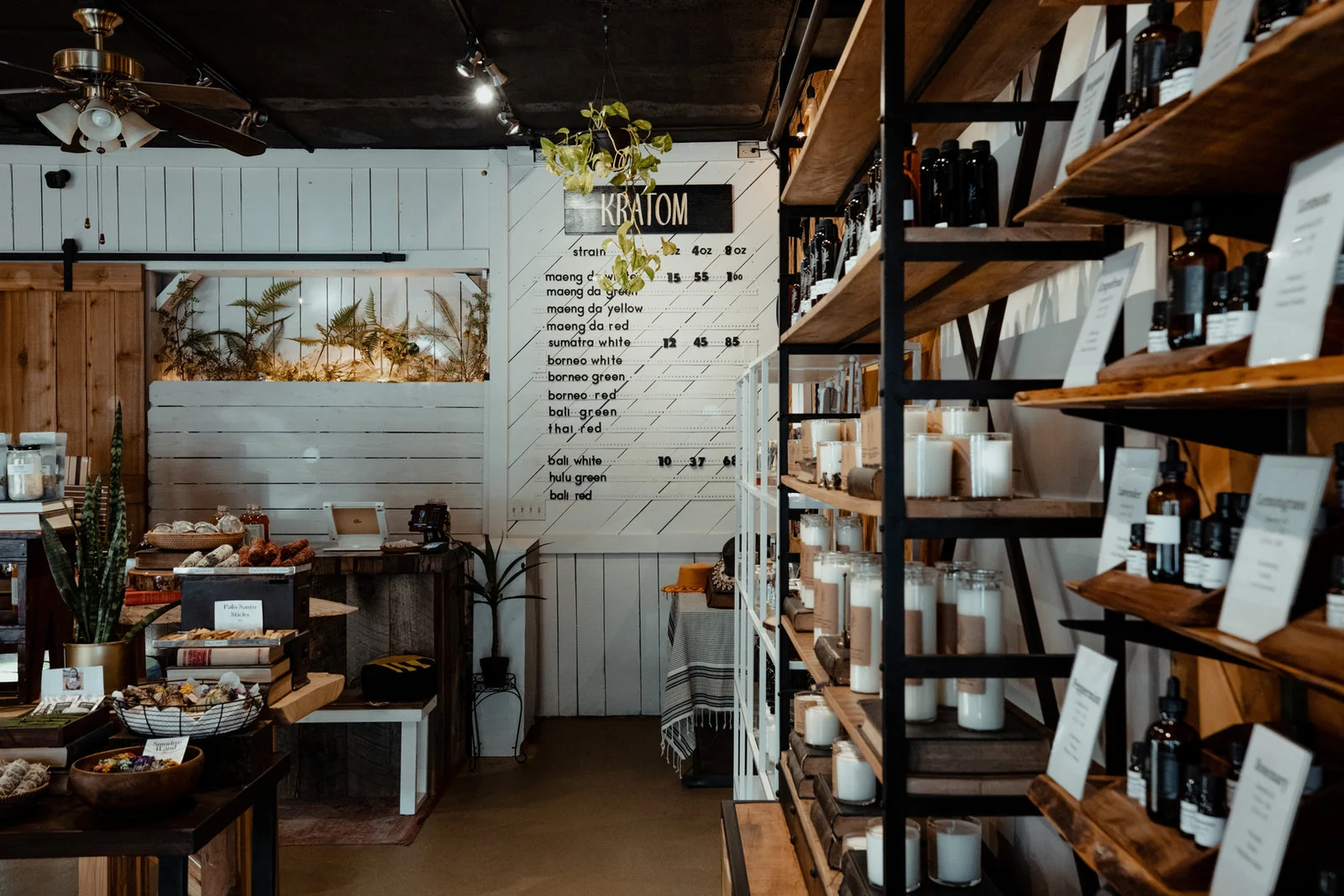 Wooden shelves and botanical products inside Terra Apothecary.