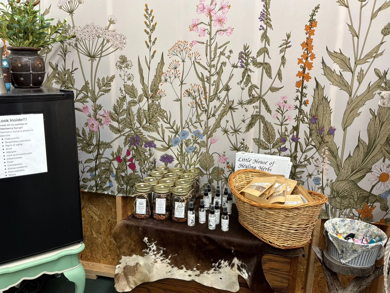 Little House of Healing Herbs display inside Zen & Alchemy, with jars of herbal blends, packaged herbs, and bottled preparations