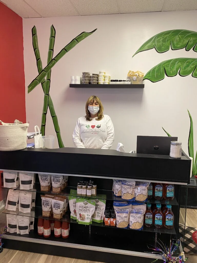 Coralee Montes behind the counter at Alkaline Healing Herbs on Division Street