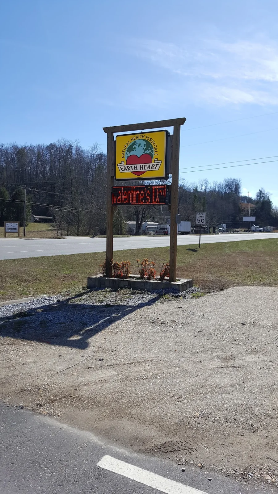 Earth Heart Health Food Store roadside sign in Marion
