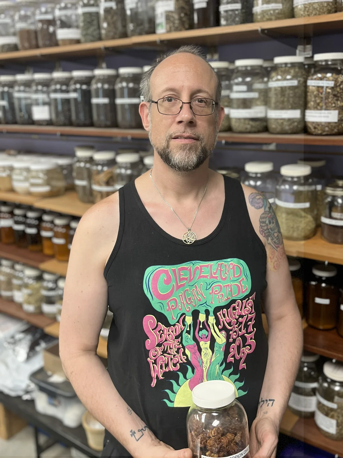 Spirit Apothecary co-owner Matt Stewart beside the shop’s herb jars